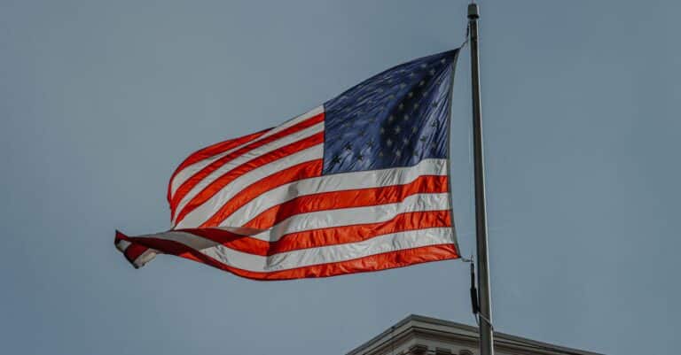 close-up-of-a-waving-american-flag-on-a-pole-against-a-cloudy-sky-in-denver-colorado-1 - AC Flag & Banner Buy Flagpoles in Colorado: Expert Guide to Types, Heights, Installation, and Where to Shop - AC Flag & Banner